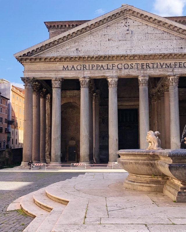 The Pantheon in Rome, showing its large portico with Corinthian columns and a fountain in the foreground.