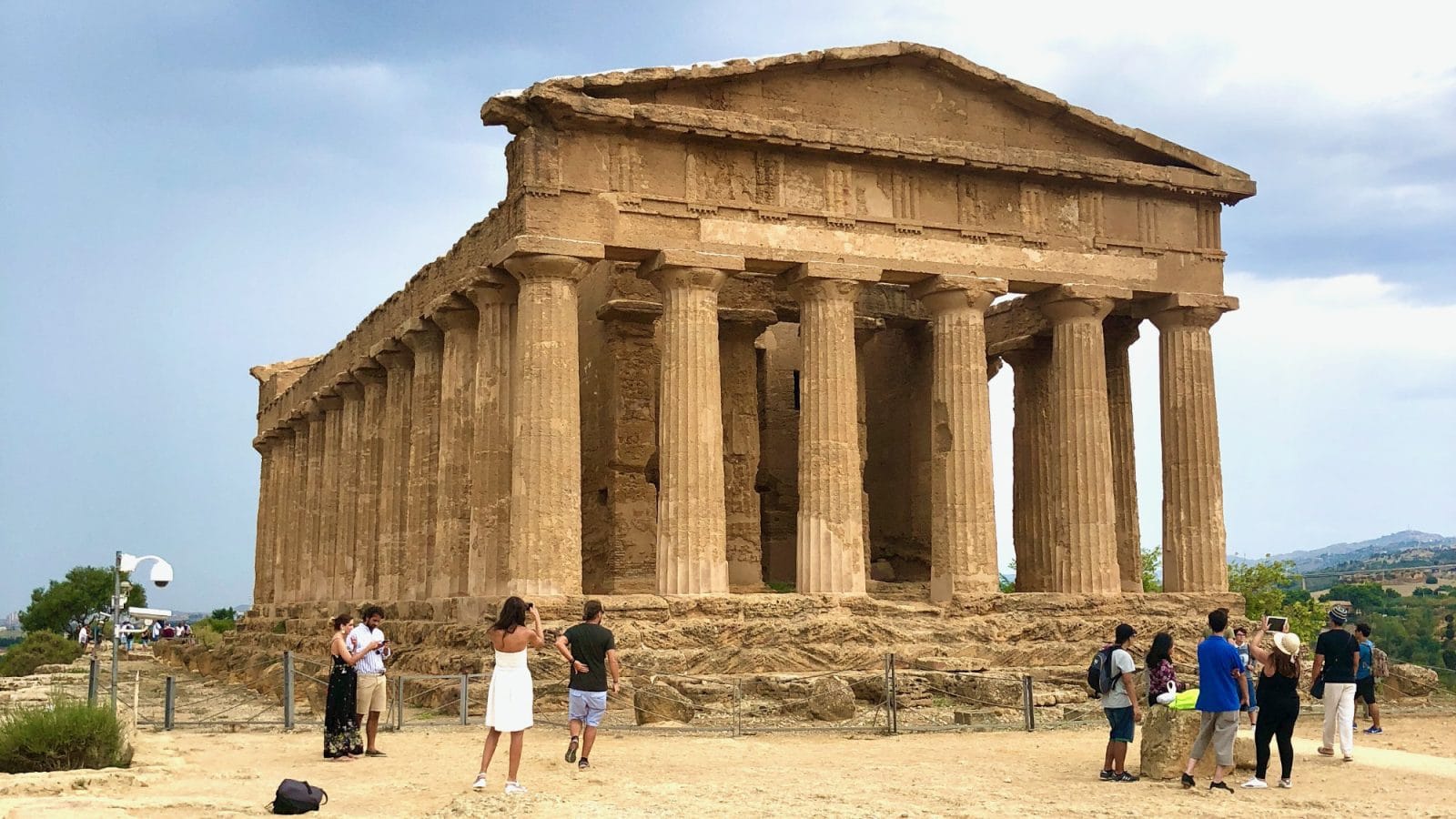 Tourists visiting the ancient Temple of Concordia in the Valley of the Temples, Sicily.