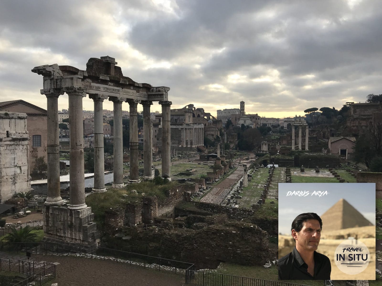 Ruins of Roman columns at the Roman Forum under a cloudy sky; an inset shows a man with text reading “Darius Arya, Travel In Situ” and a pyramid in the background.