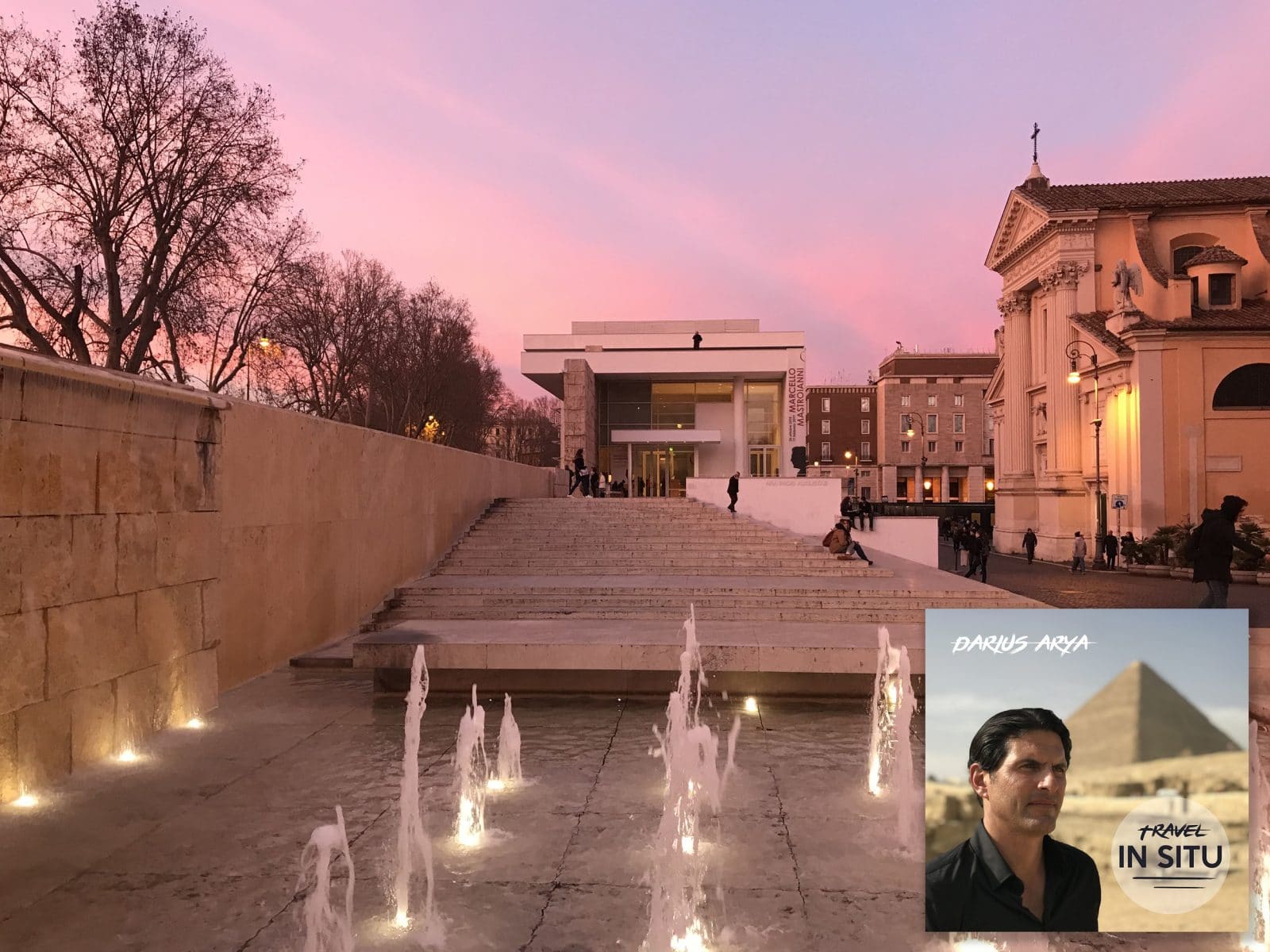 A modern building with wide steps and water fountains at sunset, bordered by trees and classical architecture; an album cover titled “Travel In Situ” is overlaid in the corner.