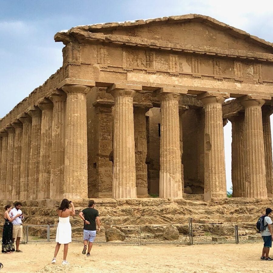 Tourists visiting the Temple of Concordia in the Valley of the Temples, Sicily.